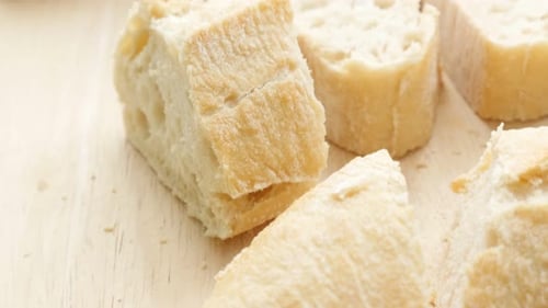 French bougette bread pieces on the table close-up 4K 2160p UltraHD slow tilt footage - French tradi