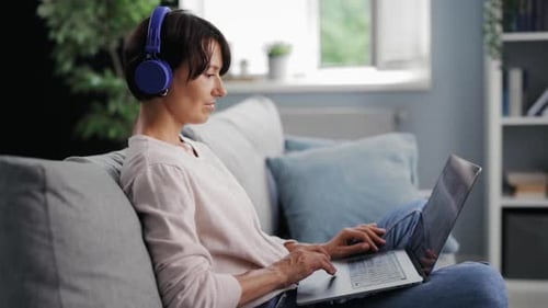 Woman Using Laptop Computer at Home
