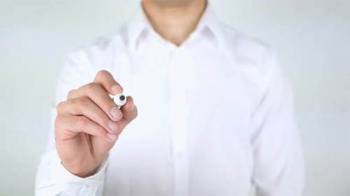 Man Writes the Word Devotion on Transparent Surface