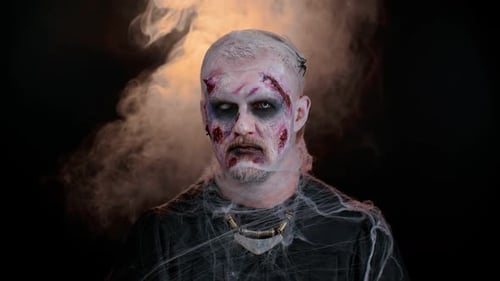 Creepy Zombie Face with Halloween Makeup and Spiderwebs