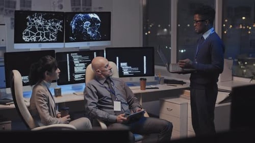 Technology Team Collaborating in Urban Office at Night