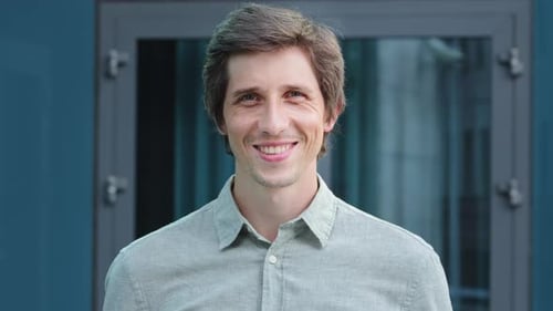 Smiling Friendly Millennial Professional Businessman Looking at Camera