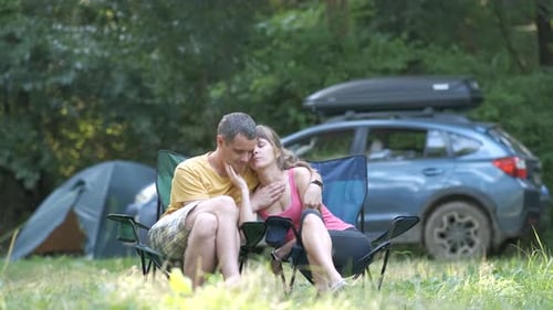 Affectionate Couple Camping in Lush Green Countryside