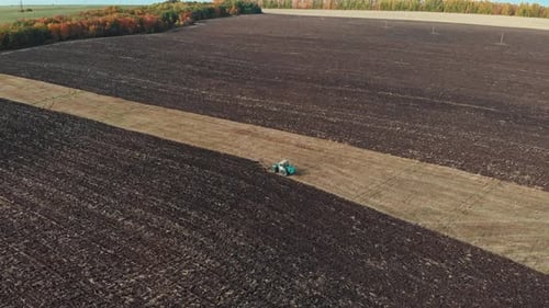 A View of Fields - Tractors Plows the Field