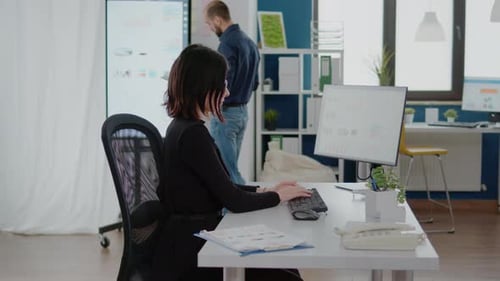 Woman Works at Computer in Modern Office