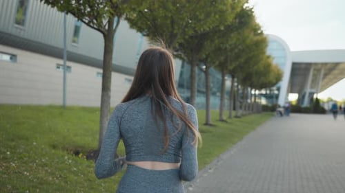 Young Fitness Sport Woman Running on Road