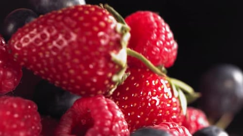 Slow Motion of Fresh Mixed Berries Falling onto a Pile