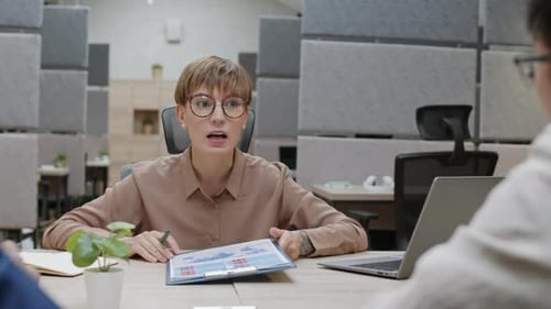 Woman Presents Business Data at Office Meeting
