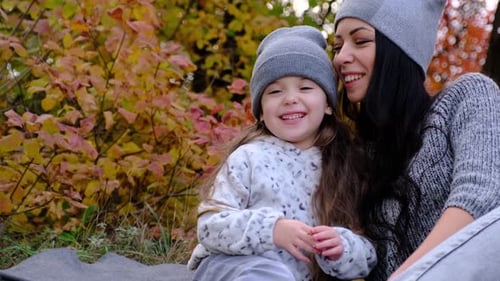Mom and Threeyearold Daughter in the Park on a Picnic