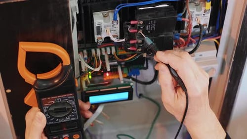 Electrician Testing Voltage on Electrical Box Wiring