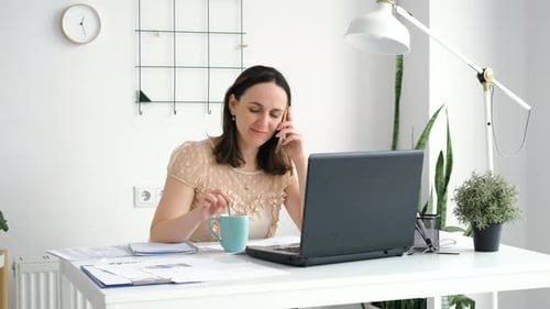 Businesswoman Talking on Phone in the Office