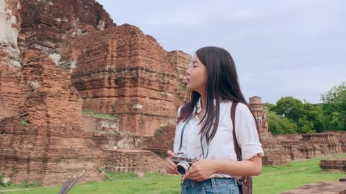 Japanese backpacker female enjoy her journey at amazing landmark in traditional city.