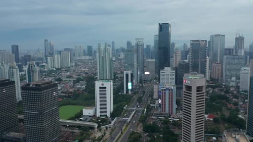 Aerial Wide View of Urban Canyon with Skyscrapers and Multi Lane Traffic in Downtown Jakarta
