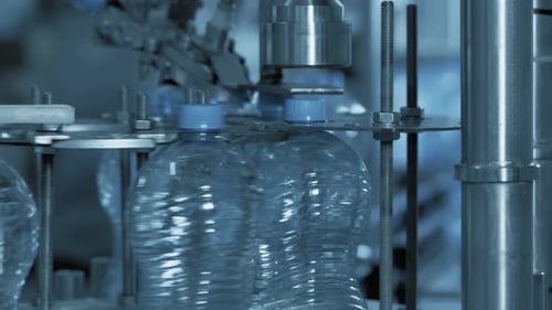 Bottles Moving on Bottling Plant Conveyor Belt