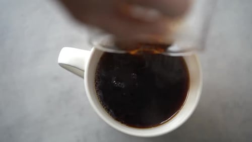 Pouring Coffee into White Mug Close Up Shot