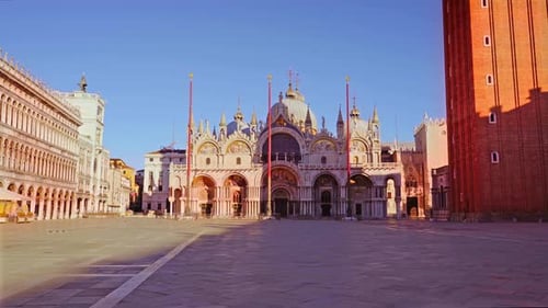 Ancient St Mark Basilica and High Red Poles on Empty Square