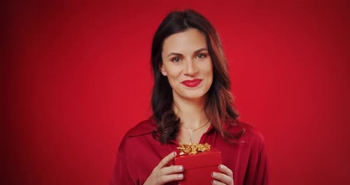Happy Woman Holding a Birthday Gift Box