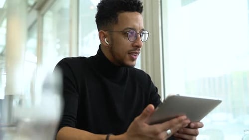 Thoughtful businessman holding digital tablet