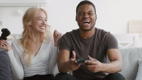 Smiling Couple Enjoying Video Games Together at Home