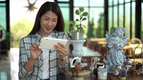 happy woman using digital tablet in a cafe