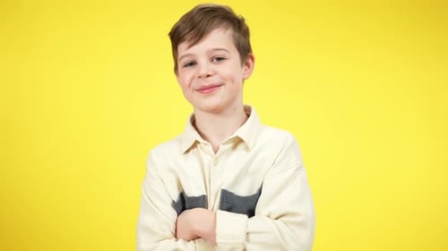Middle Shot Portrait of Positive Confident Caucasian Boy Crossing Hands Looking at Camera