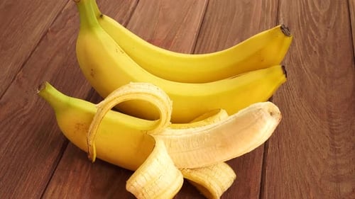 Fresh Yellow Bananas on Wooden Background