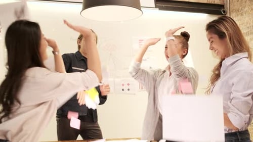 Cheerful Colleagues Celebrating Success in Modern Office