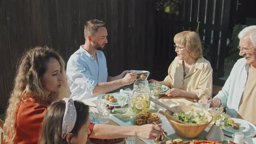 Family Meal Outdoors on Sunny Day