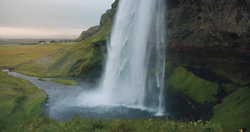 Majestic Waterfall Cascading in Green Landscape