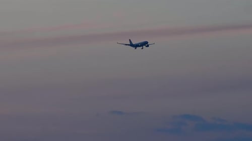 Widebody Airplane Final Approaching at Sunset