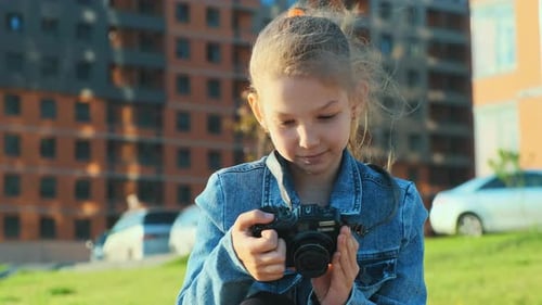 Girl with Camera Taking Photos Outside