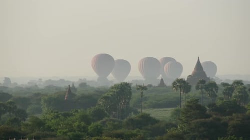 Balloons landing together close to the Pagodas in Bagan
