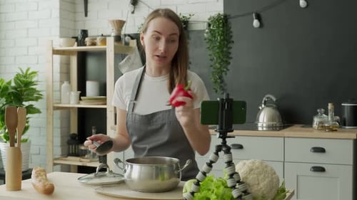 Woman Making Cooking Video in Bright Kitchen