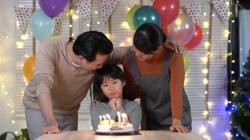 Happy Family Celebrates Child's Birthday with Cake