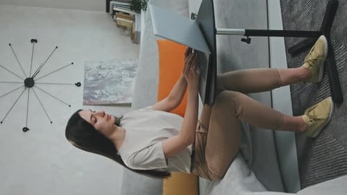 Woman using Laptop in Home Living Room