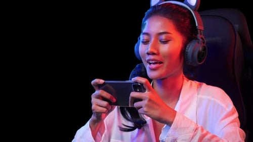 Woman Playing Mobile Game in Gaming Chair