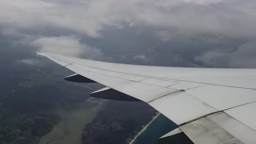 Wing of the Plane and Clouds View From the Plane
