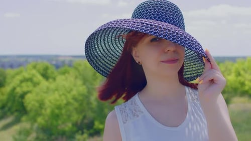 Woman Smiling Wearing Sunhat with Breezy Auburn Hair