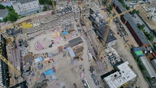 Construction site with neatly stacked building materials. Drone footage
