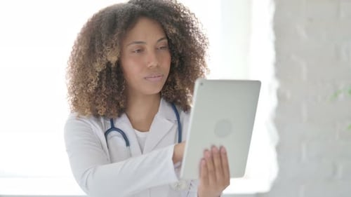 Afrcian Doctor using Tablet in Clinic