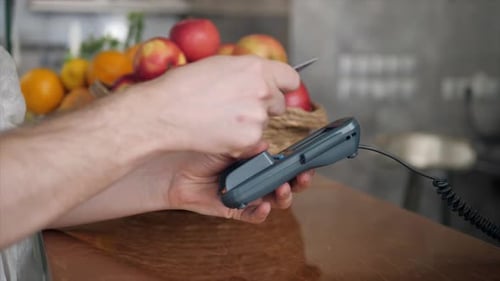 Closeup of Woman Making Payment Through NFC in Bakery Cafe Restaurant Mobile Phone Contactless Pay