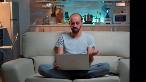 Young Adult on Laptop Video Call at Home