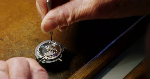 Close-up of horologist repairing a watch