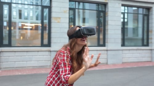 Woman Experiencing Virtual Reality Headset in Urban Setting