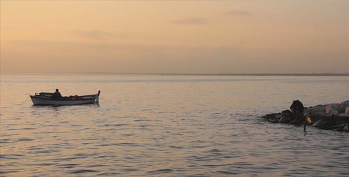 Sunset at Sea with Boat on Calm Water