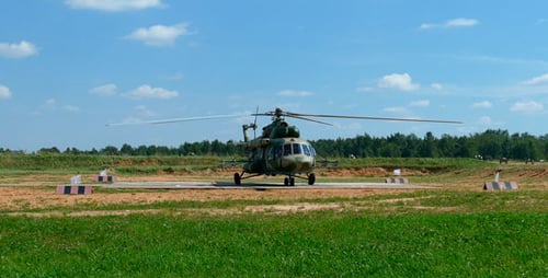 Military Helicopter Rotating Blades on Rural Landing Pad