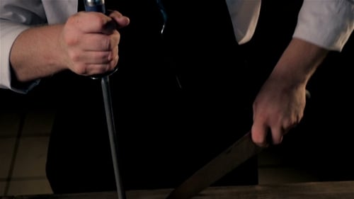 Chef Sharpening Knife with Steel Before Cutting Meat