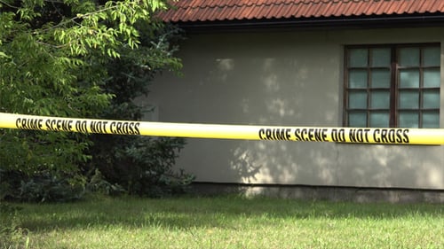 House exterior behind crime scene tape