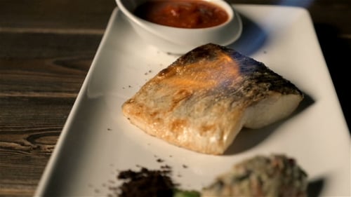 Piece of Fish Being Torched on Plate