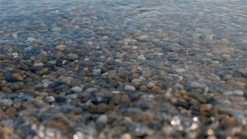 Sea Braking Against Stones And Pebbles On a Beach, Waves Of Pure Water
